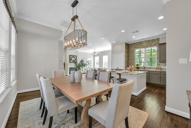 dining area with dark wood finished floors, recessed lighting, baseboards, visible vents, and ornamental molding