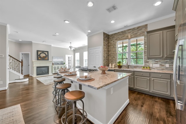kitchen with crown molding, visible vents, a wealth of natural light, and gray cabinets
