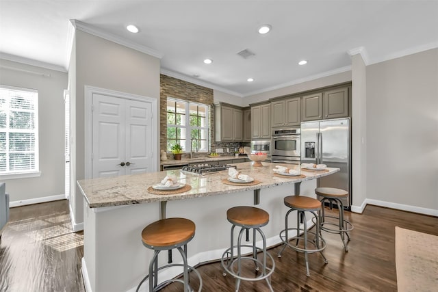 kitchen featuring gray cabinetry, baseboards, ornamental molding, and stainless steel appliances
