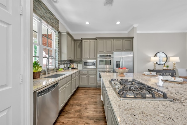 kitchen featuring a sink, appliances with stainless steel finishes, ornamental molding, and gray cabinetry