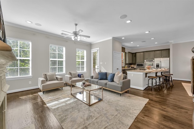 living area with crown molding, baseboards, ceiling fan, and dark wood-style flooring