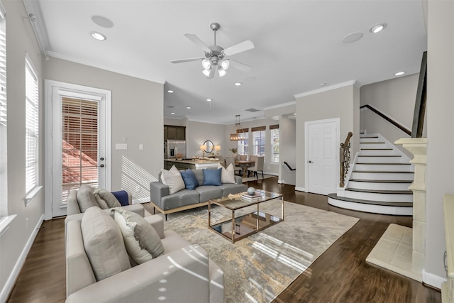 living room with ornamental molding, stairs, baseboards, a ceiling fan, and dark wood finished floors