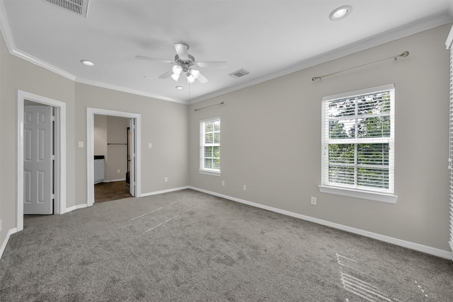 unfurnished bedroom with crown molding, carpet flooring, visible vents, and baseboards