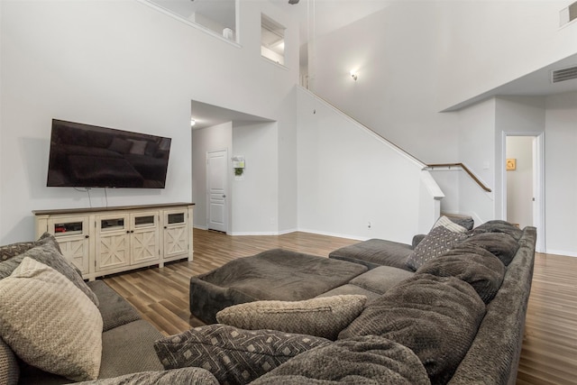 522 Pequin Rd, Crosby, TX 77532 - living area with stairs, baseboards, wood finished floors, a towering ceiling, and visible vents