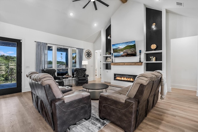 224 Kellog, Fischer, TX 78623 - living area with a ceiling fan, high vaulted ceiling, a glass covered fireplace, wood finished floors, and baseboards