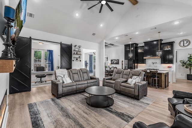 224 Kellog, Fischer, TX 78623 - living area featuring a barn door, a ceiling fan, high vaulted ceiling, light wood finished floors, and beam ceiling