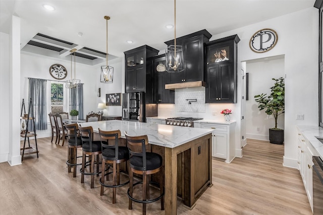 224 Kellog, Fischer, TX 78623 - kitchen with a chandelier, dark cabinetry, stainless steel refrigerator with ice dispenser, backsplash, and recessed lighting