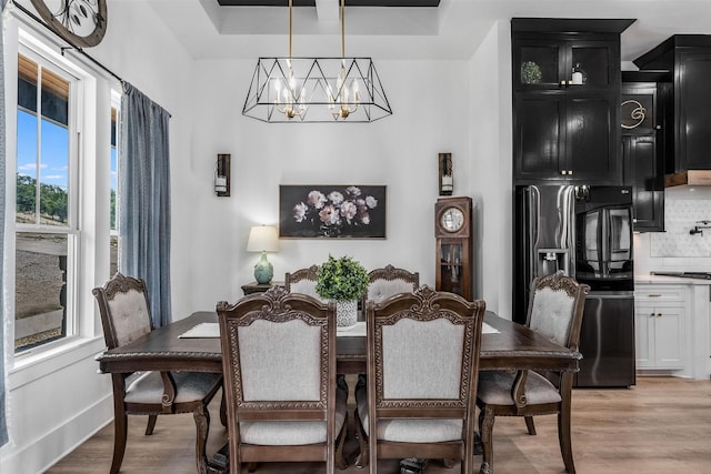 224 Kellog, Fischer, TX 78623 - dining room featuring a chandelier, light wood finished floors, and baseboards
