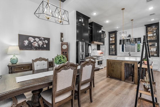 224 Kellog, Fischer, TX 78623 - dining room featuring a chandelier, light wood finished floors, and recessed lighting