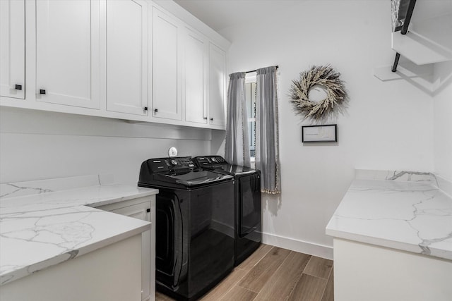 224 Kellog, Fischer, TX 78623 - laundry room featuring cabinet space, washer and dryer, wood finished floors, and baseboards