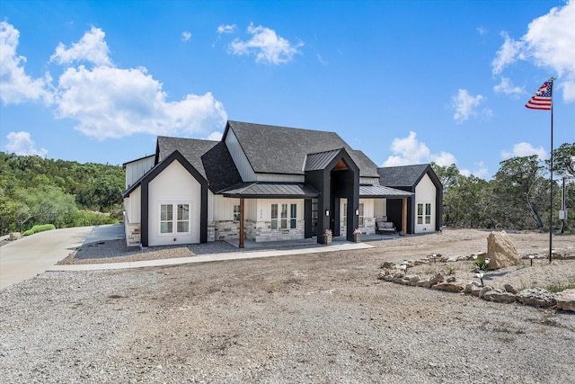 224 Kellog, Fischer, TX 78623 - modern farmhouse with a standing seam roof, metal roof, stone siding, and a shingled roof