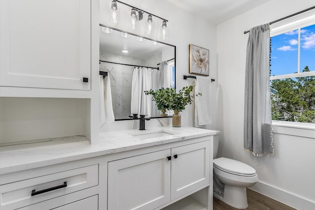 224 Kellog, Fischer, TX 78623 - full bath featuring wood finished floors, healthy amount of natural light, toilet, and vanity