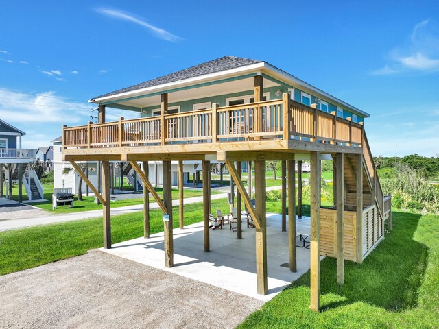 1062 Cedar Ln, Gilchrist, TX 77617 - view of play area featuring a lawn, stairs, and a deck