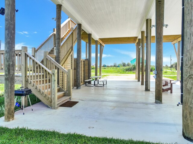 1062 Cedar Ln, Gilchrist, TX 77617 - view of patio featuring stairs and area for grilling