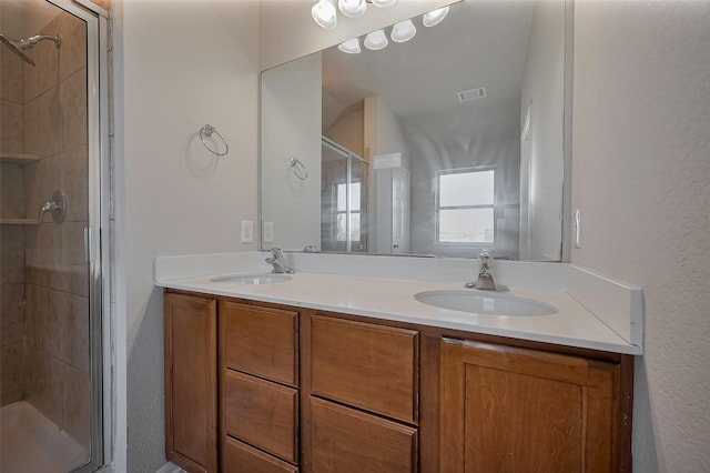 24114 Morrison Ln, Katy, TX 77493 - bathroom featuring double vanity, visible vents, a sink, and a stall shower