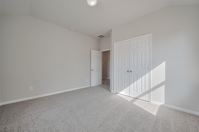 24114 Morrison Ln, Katy, TX 77493 - unfurnished bedroom featuring visible vents, baseboards, a closet, lofted ceiling, and carpet