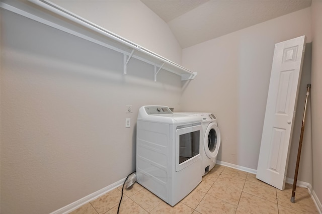 24114 Morrison Ln, Katy, TX 77493 - laundry room with laundry area, washer and clothes dryer, baseboards, and light tile patterned floors