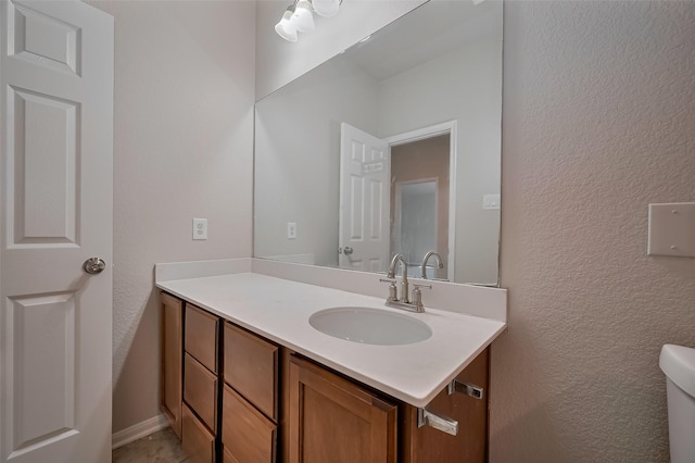 24114 Morrison Ln, Katy, TX 77493 - half bath with vanity, a textured wall, and toilet