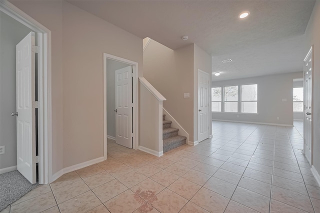 24114 Morrison Ln, Katy, TX 77493 - spare room featuring recessed lighting, baseboards, light tile patterned floors, and stairway