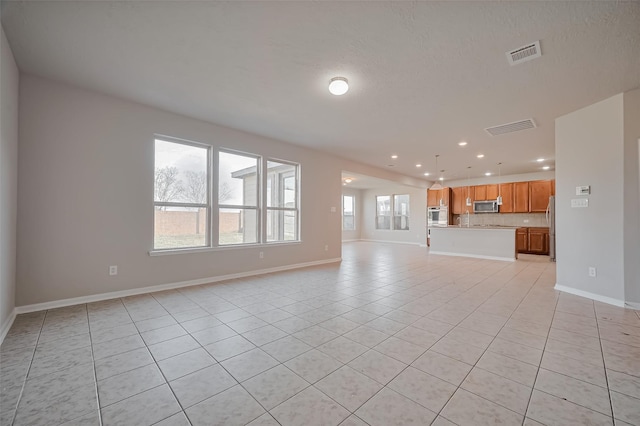 24114 Morrison Ln, Katy, TX 77493 - unfurnished living room with recessed lighting, baseboards, visible vents, and light tile patterned floors