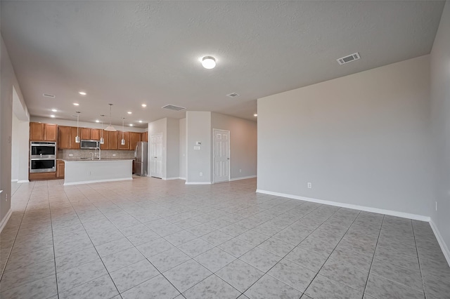 24114 Morrison Ln, Katy, TX 77493 - unfurnished living room with recessed lighting, baseboards, visible vents, and light tile patterned floors