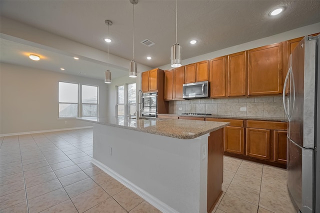 24114 Morrison Ln, Katy, TX 77493 - kitchen featuring brown cabinets, stainless steel appliances, visible vents, and decorative backsplash