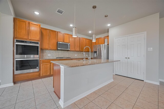 24114 Morrison Ln, Katy, TX 77493 - kitchen featuring a sink, light tile patterned floors, tasteful backsplash, and stainless steel appliances