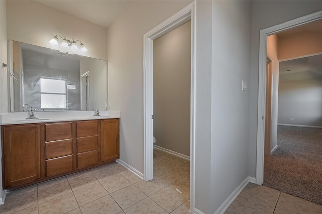 24114 Morrison Ln, Katy, TX 77493 - bathroom with tile patterned flooring, a sink, double vanity, and toilet