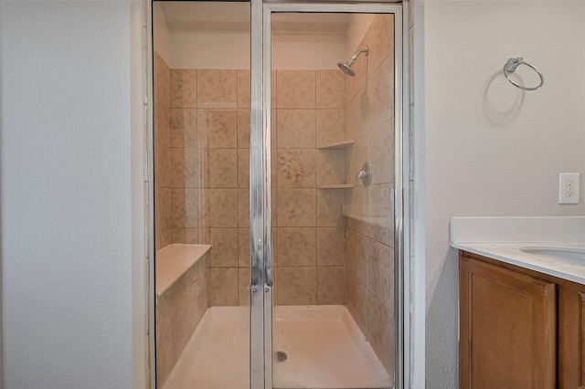 24114 Morrison Ln, Katy, TX 77493 - full bathroom with a textured wall, a shower stall, and vanity