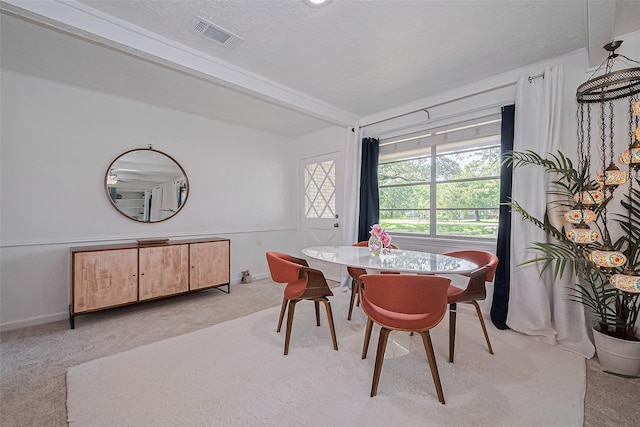 13018 Vernon Rd, Cypress, TX 77429 - dining room with light colored carpet, a textured ceiling, and beamed ceiling