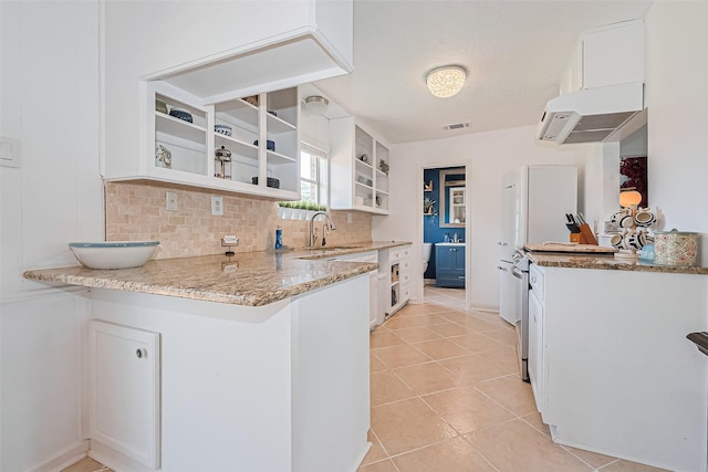 13018 Vernon Rd, Cypress, TX 77429 - kitchen featuring open shelves, a sink, white cabinets, and light stone countertops
