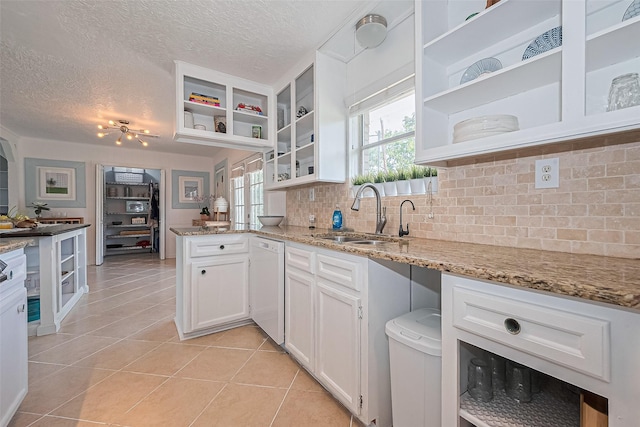 13018 Vernon Rd, Cypress, TX 77429 - kitchen featuring a sink, open shelves, dishwasher, white cabinetry, and a textured ceiling