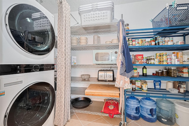 13018 Vernon Rd, Cypress, TX 77429 - laundry room featuring estacked washer and dryer and tile patterned flooring