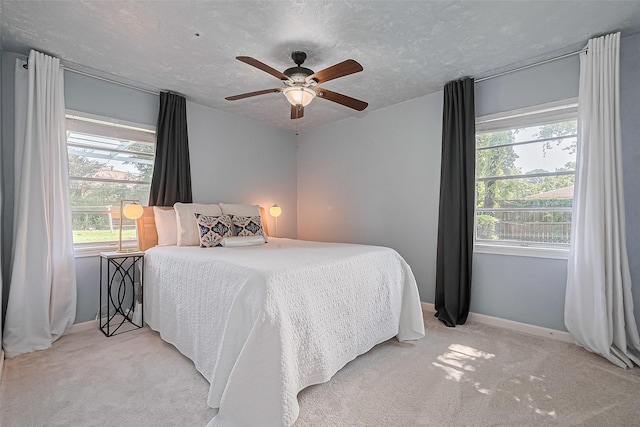 13018 Vernon Rd, Cypress, TX 77429 - carpeted bedroom with baseboards, a ceiling fan, and a textured ceiling