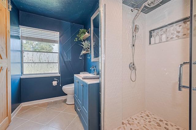 13018 Vernon Rd, Cypress, TX 77429 - full bath with a stall shower, tile patterned floors, toilet, vanity, and baseboards
