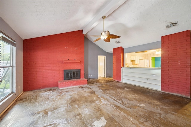 unfurnished living room with a brick fireplace, ceiling fan, and a textured ceiling
