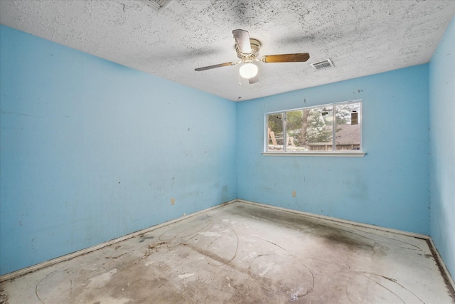 unfurnished room with ceiling fan and a textured ceiling