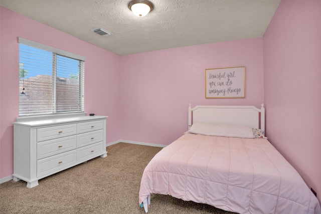 5009 Deerpath Dr, Conroe, TX 77303 - bedroom with baseboards, light carpet, a textured ceiling, and visible vents