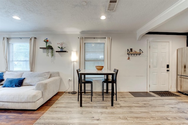 708 Gresham St, Baytown, TX 77520 - dining area featuring crown molding, a textured ceiling, and wood finished floors