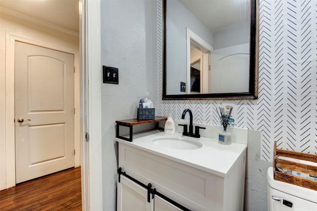 708 Gresham St, Baytown, TX 77520 - half bathroom featuring crown molding, vanity, and wood finished floors