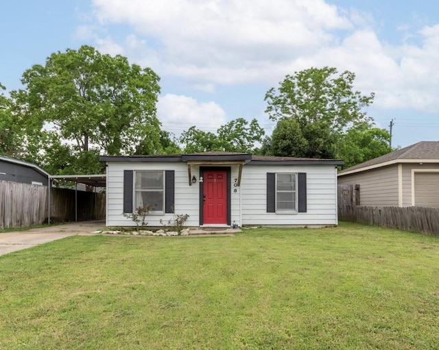 708 Gresham St, Baytown, TX 77520 - view of front of house with fence, driveway, a carport, and a front lawn