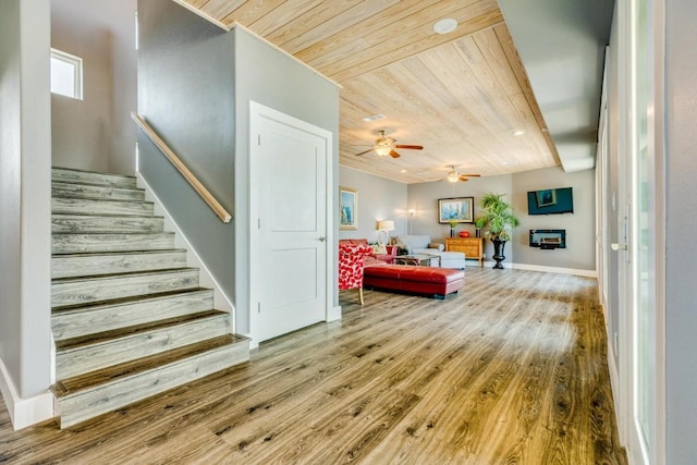 2386 Hwy 87, Gilchrist, TX 77617 - living area featuring wood ceiling, ceiling fan, stairs, and wood finished floors