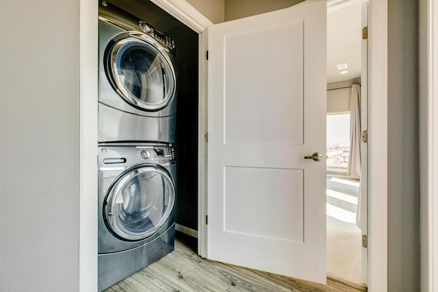 2386 Hwy 87, Gilchrist, TX 77617 - washroom with laundry area, wood finished floors, and stacked washer and clothes dryer