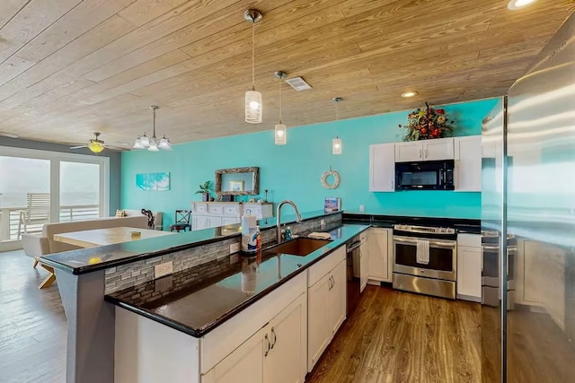 2386 Hwy 87, Gilchrist, TX 77617 - kitchen featuring dark countertops, wood ceiling, white cabinets, a sink, and black appliances