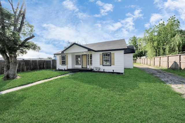 view of front of house featuring a porch, a fenced backyard, and a front lawn