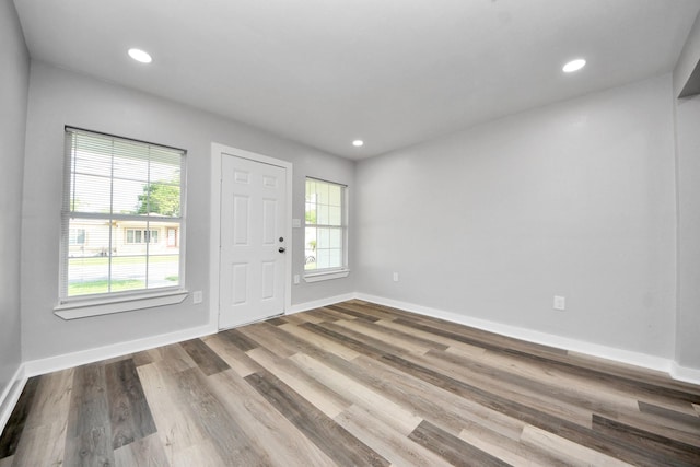 entryway with baseboards, recessed lighting, and wood finished floors