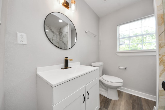 full bath with walk in shower, vanity, toilet, baseboards, and wood finished floors