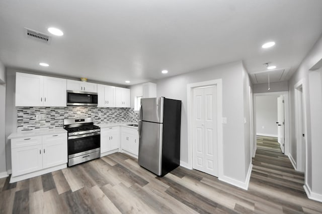 kitchen with visible vents, light countertops, white cabinetry, and appliances with stainless steel finishes