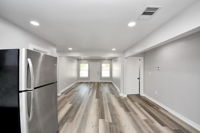 kitchen with freestanding refrigerator, recessed lighting, baseboards, wood finished floors, and visible vents