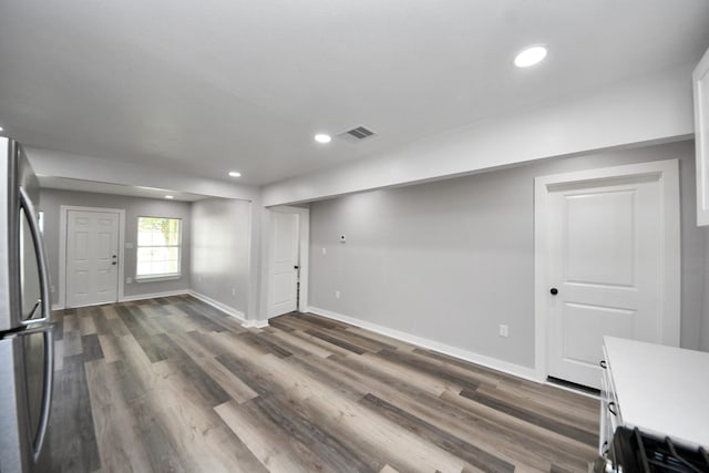 interior space with dark wood-style flooring, baseboards, visible vents, and recessed lighting